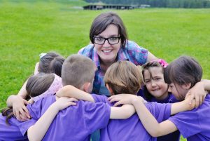 happy kids with camp counselor